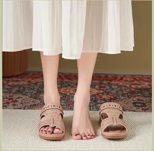 Elegant beige wedge sandals featuring intricate laser-cut patterns and a comfortable peep-toe.