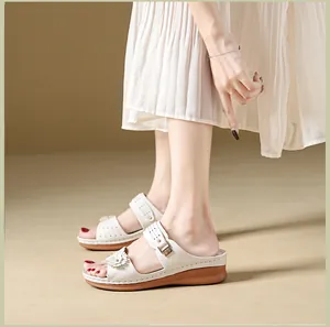 Detailed view of women's wedge slippers featuring retro stitching and flower decor