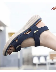 Side view of women's blue athletic sandals with chunky soles and gold accents.