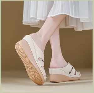Close-up detail of cream-colored women's wedge sandals with anti-slip wavy rubber sole