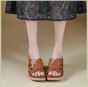 Front view of brown leather wedge sandals with woven straps and platform sole.