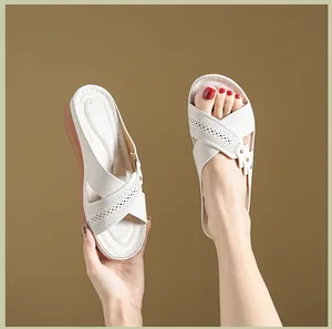 Close-up of beige platform wedge sandals with perforated crisscross straps for women
