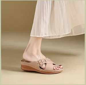 Close-up profile of a beige wedge sandal featuring laser-cut decorative straps and comfort sole