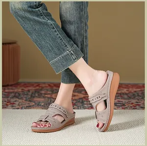 Detailed view of stylish hollow-out wedge sandals for women on a cozy textured rug