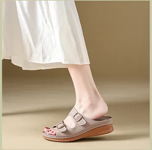 Side view of stylish beige wedge platform sandals with double buckle straps on a model