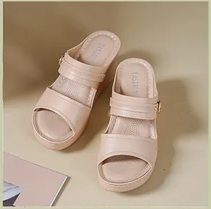 Detail view of comfortable beige platform wedge sandals with perforated straps