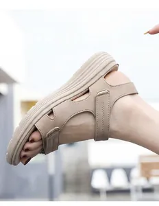 Detail view of beige women's athletic sandals with adjustable velcro straps and thick soles.