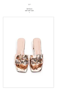 Close-up detail of stylish rose gold metallic pleated block heel slide shoes
