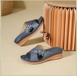 Elegant navy blue wedge sandals with perforated floral details and gold studs decoration