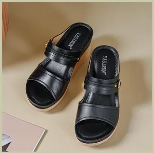 Detailed view of black women's wedge sandals featuring double straps and comfortable thick soles