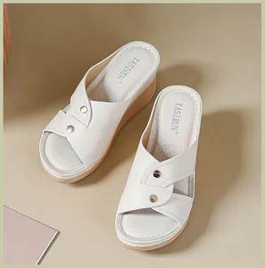 Elegant off-white wedge sandals for women with cross-strap design and metal studs