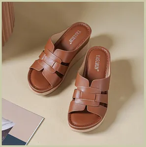 Macro view of brown platform sandals with intricate woven faux leather straps on a beige background