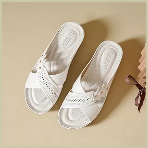 Detailed top view of comfortable white wedge sandals with breathable laser-cut patterns