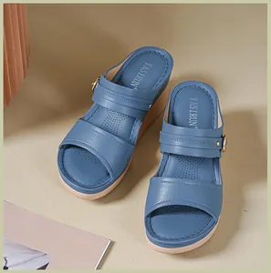 Close-up of stylish blue wedge sandals with elegant stitching and comfortable straps.