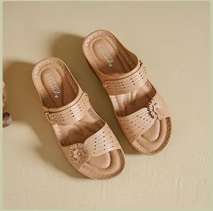 Close-up of retro floral wedge sandals featuring laser-cut patterns and contrast stitching.