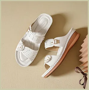 Detailed view of white floral wedge sandals with retro stitching and comfortable thick sole.