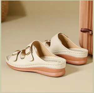 Side view of beige platform wedge sandals with adjustable double metal buckles