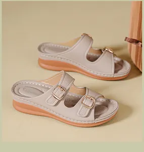 Elegant beige women's wedge sandals with adjustable double buckles and thick soles.