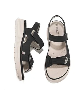 Detailed view of women's black sporty sandals with hook-and-loop straps and platform sole