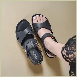 Detailed top view of black platform sandals featuring cross straps and metal buckles