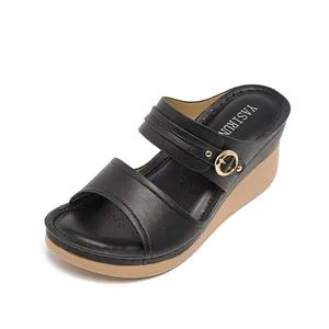 Comfortable black leather wedge sandals for women featuring stylish golden buckle decoration