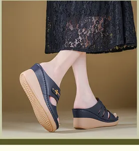 Detailed view of navy blue wedge sandals featuring decorative studs and a tan sole.