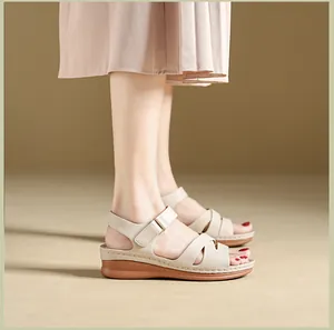 Side view of beige wedge sandals with velcro straps and a brown platform sole.