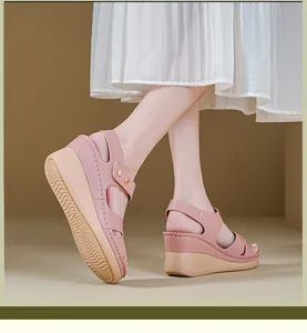 Close-up of pink women's wedge sandals with metal buckle and textured non-slip rubber sole