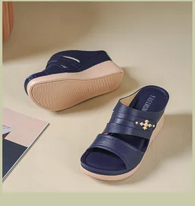 Close-up detail view of navy blue women wedge sandals with golden buckle decoration