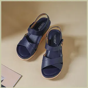 Stylish navy blue women's platform wedge sandals with cross straps and Yasirun logo