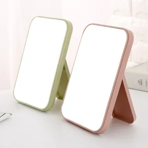 Large portable folding desktop makeup mirror for dormitory and bedroom vanity use.