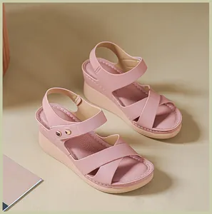 Detailed view of pink platform sandals with soft leather finish and metal buckle.