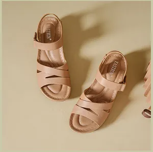 Detailed top-down view of women's wedge sandals with cross straps and velcro buckle