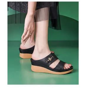 Side view detail of black wedge sandals for women with metallic strap accents