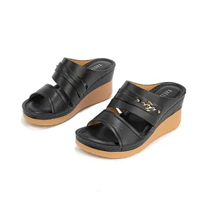 Elegant black women's wedge sandals with decorative gold metal hardware and slip-on design