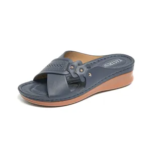 Comfortable women's navy blue wedge sandals with laser-cut straps and metal studs