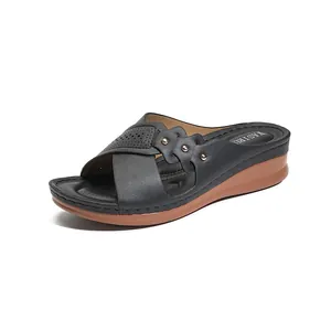 Comfortable black women's wedge slide sandals featuring laser-cut detailing and studs