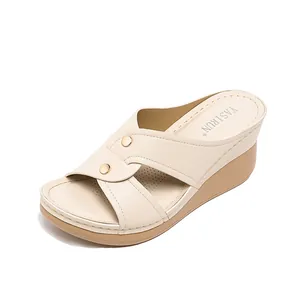 Comfortable beige wedge sandals for women with stylish cross straps and gold buttons