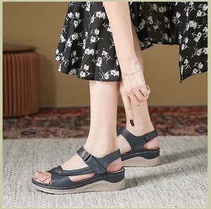 Close-up detail of stylish navy blue wedge sandals with adjustable hook and loop strap
