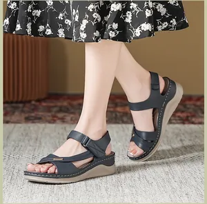 Navy blue women's wedge sandals with comfort stitching and cross-strap detail