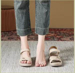 Detail view of beige wedge sandals with cross-stitch design for women's comfort.