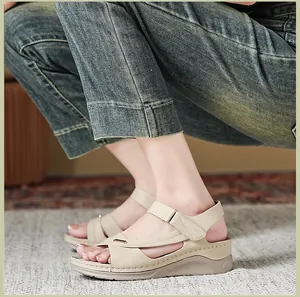 Detailed side view of beige wedge sandals for women featuring comfortable stitch detailing