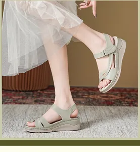 Detailed view of pale green wedge sandals for women with comfortable cross straps