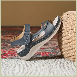 Close-up of navy blue wedge sandal with contrast stitching and comfortable thick sole