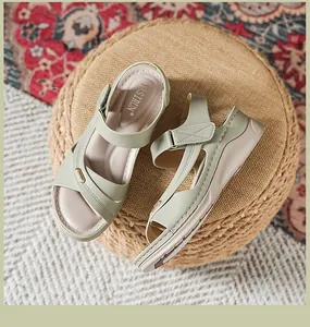 Stylish sage green women's wedge sandals featuring refined decorative stitching.