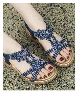 Detail of Bohemian blue wedge sandals featuring intricate rhinestone flower design