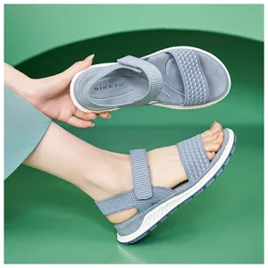 Detailed view of breathable blue knitted sports sandals with adjustable Velcro straps