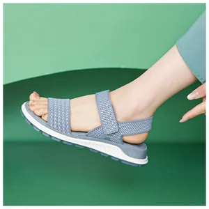 Detail showing the breathable knitted texture of the blue sports sandal on foot.