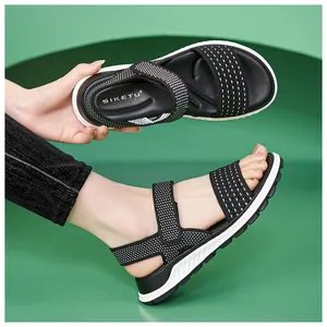 Detailed view of women's black fly-knit sandals with white dot patterns and TPR sole