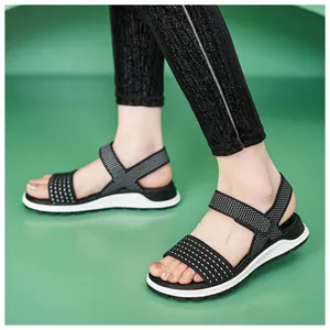 Detailed view of women's black fly-knit sports sandals with flexible white TPR sole